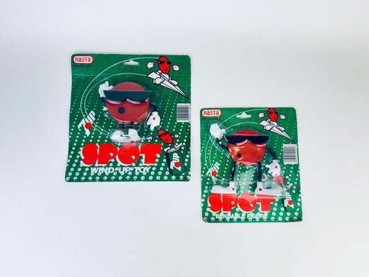 Two vintage 'Spot' toy figurines in their packaging on a white background