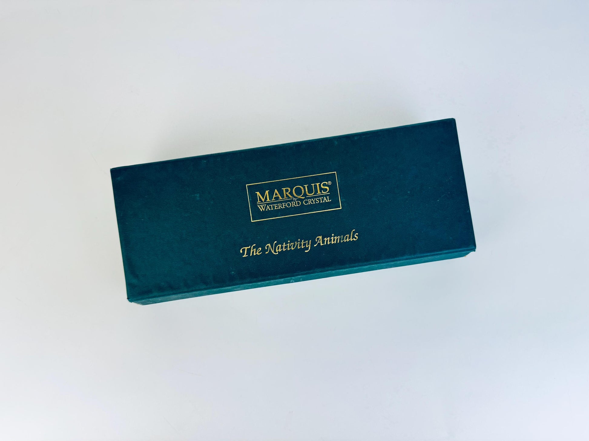 Exterior of original green Marquis by Waterford presentation box for crystal nativity animals, with gold logo text.