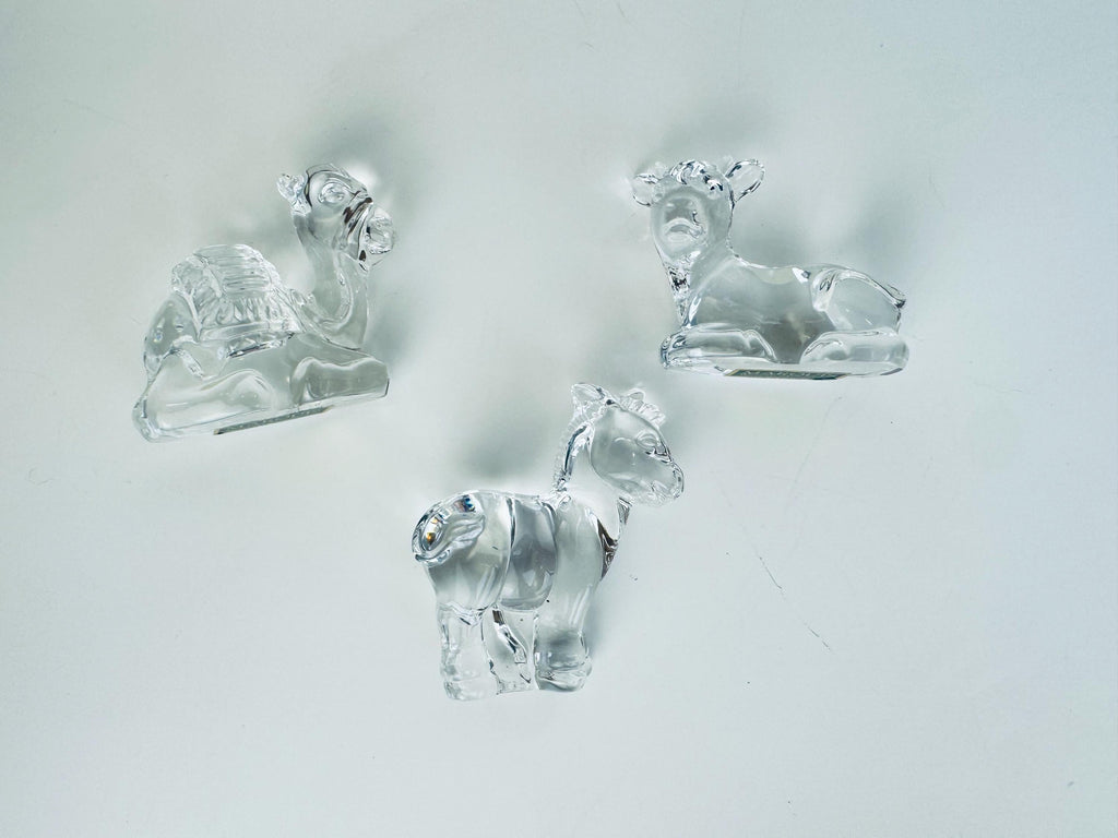 Group view of Marquis by Waterford crystal nativity animals showing cow, donkey, and camel in clear crystal.