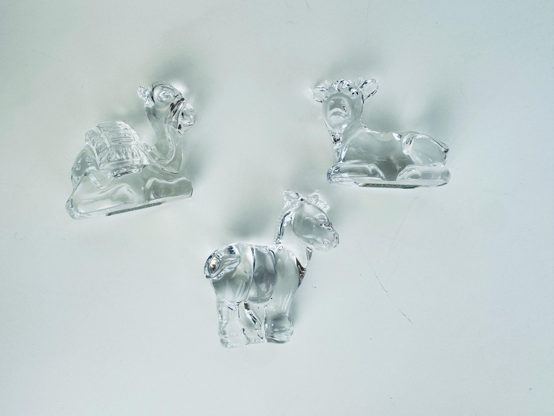 Group view of Marquis by Waterford crystal nativity animals showing cow, donkey, and camel in clear crystal.