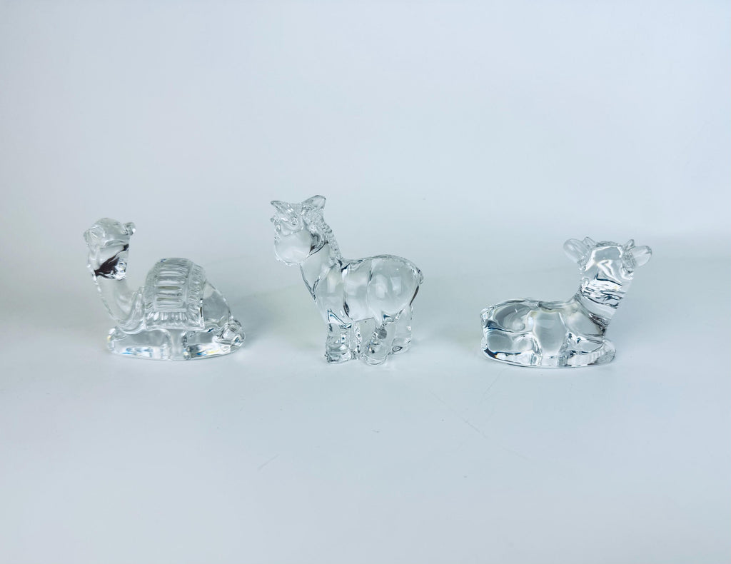 All three crystal nativity animals — cow, donkey, camel — arranged together on white background