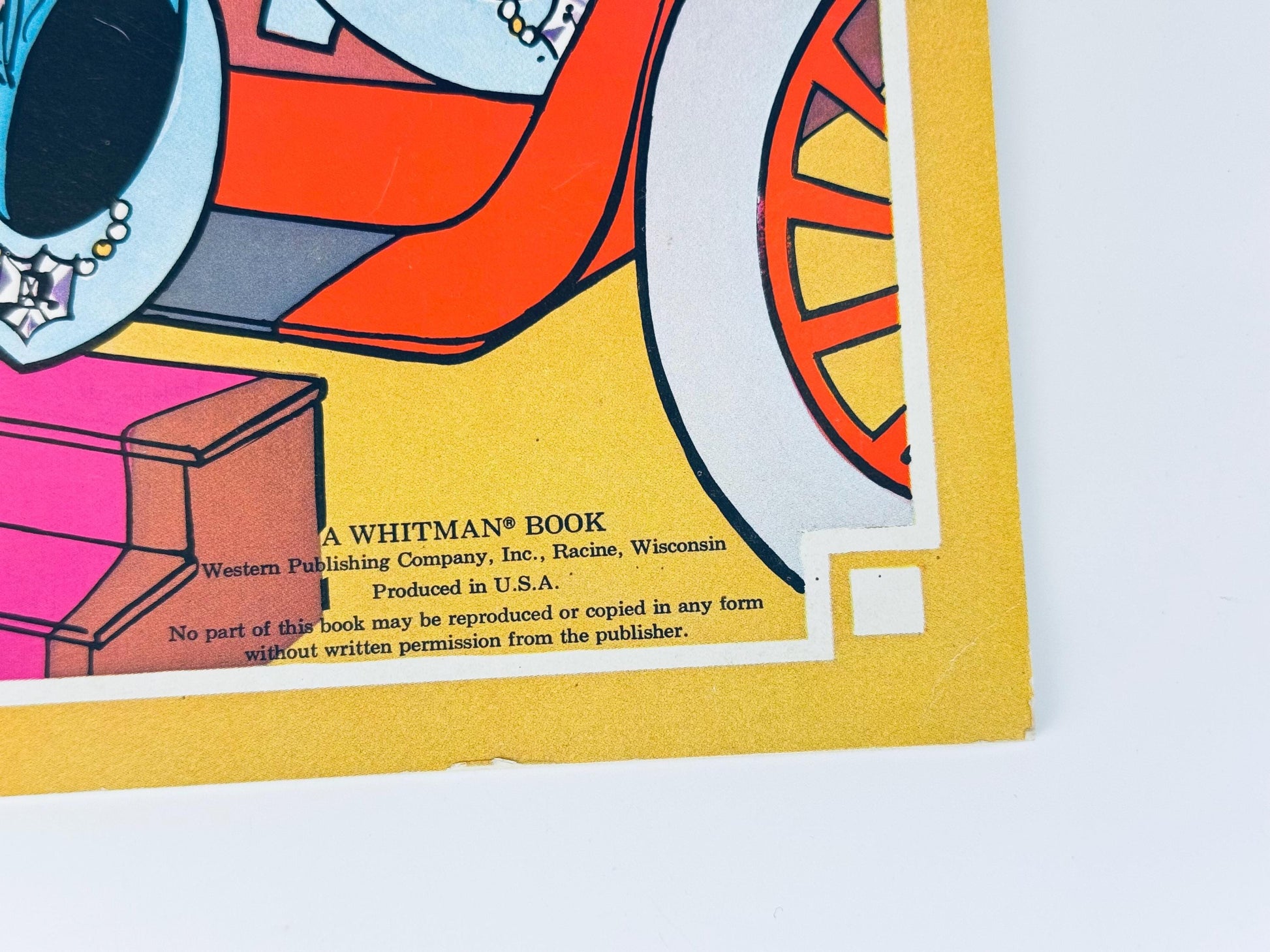 Close-up of lower corner of cover showing illustration details and edges of paper