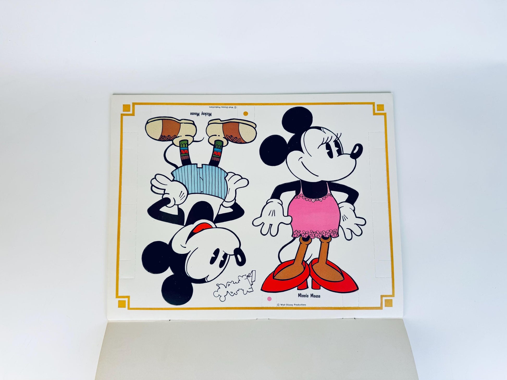 Interior page with uncut Mickey and Minnie paper dolls printed in black and white outlines