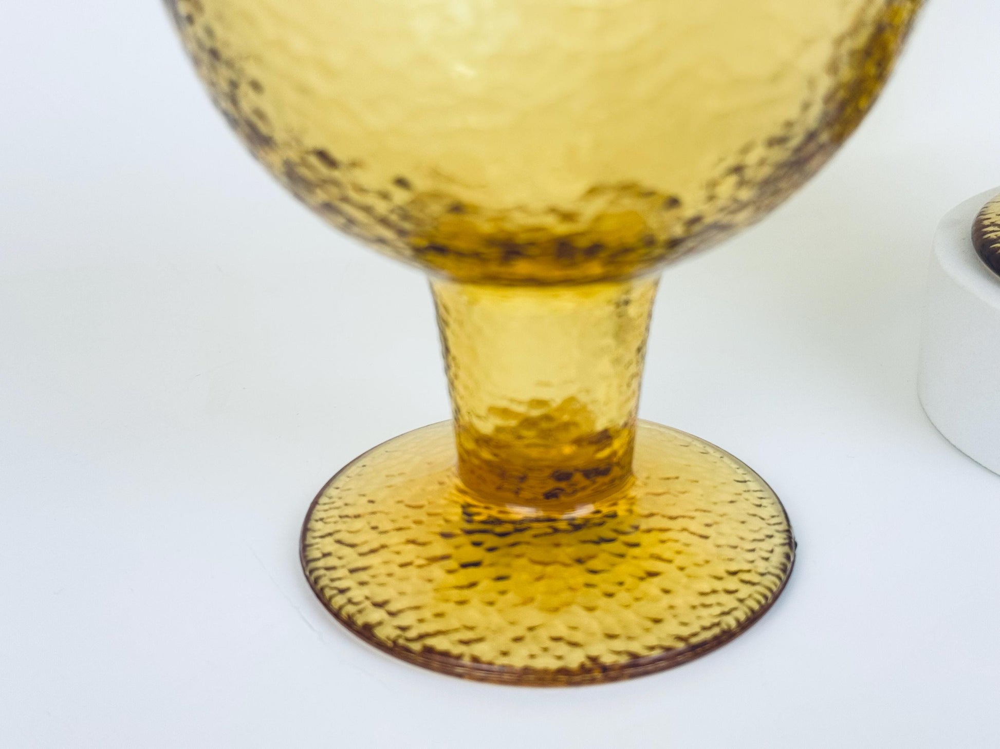Single amber goblet with wide bowl and thick stem in golden textured glass