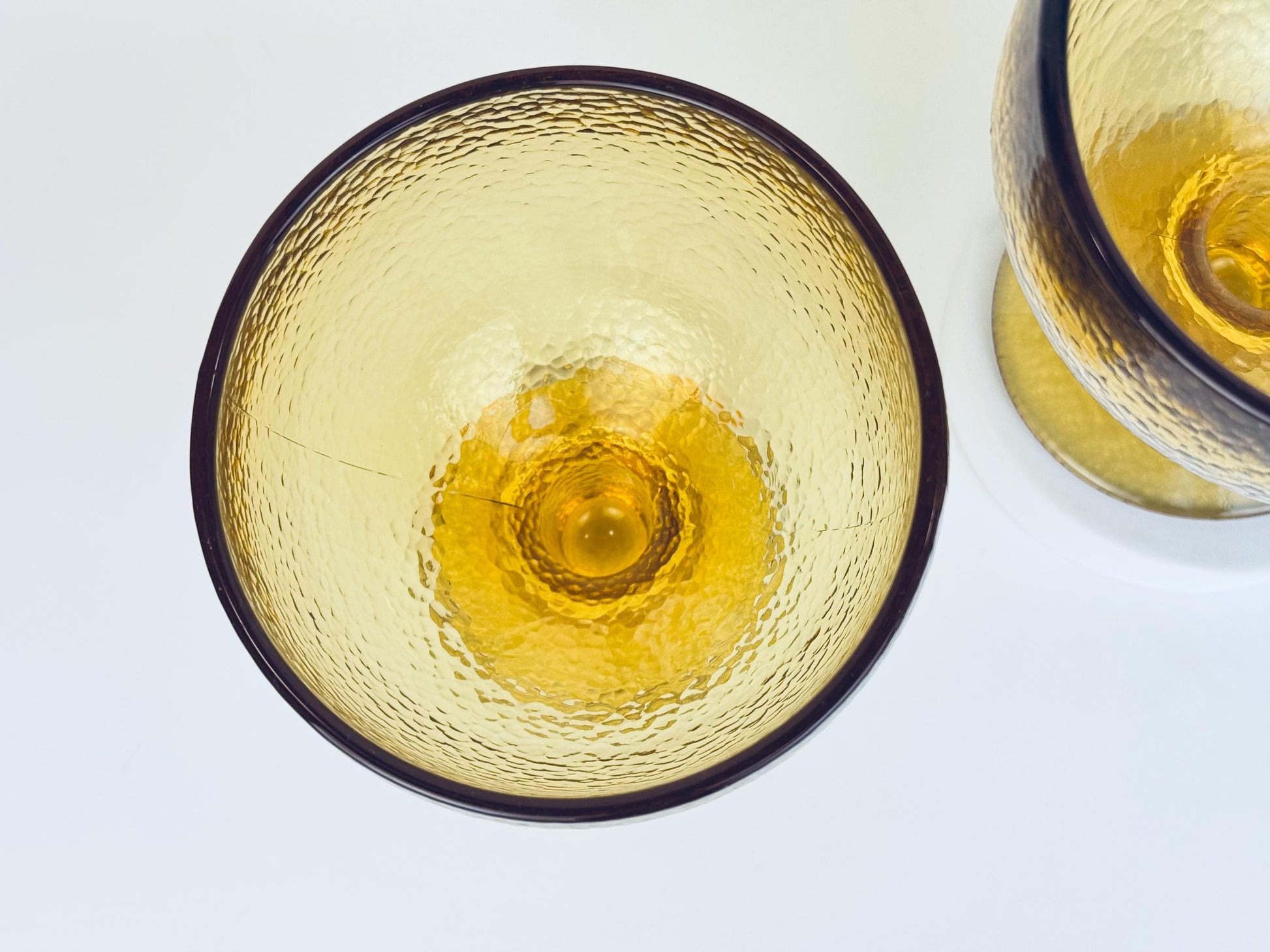 Single amber goblet with wide bowl and thick stem in golden textured glass