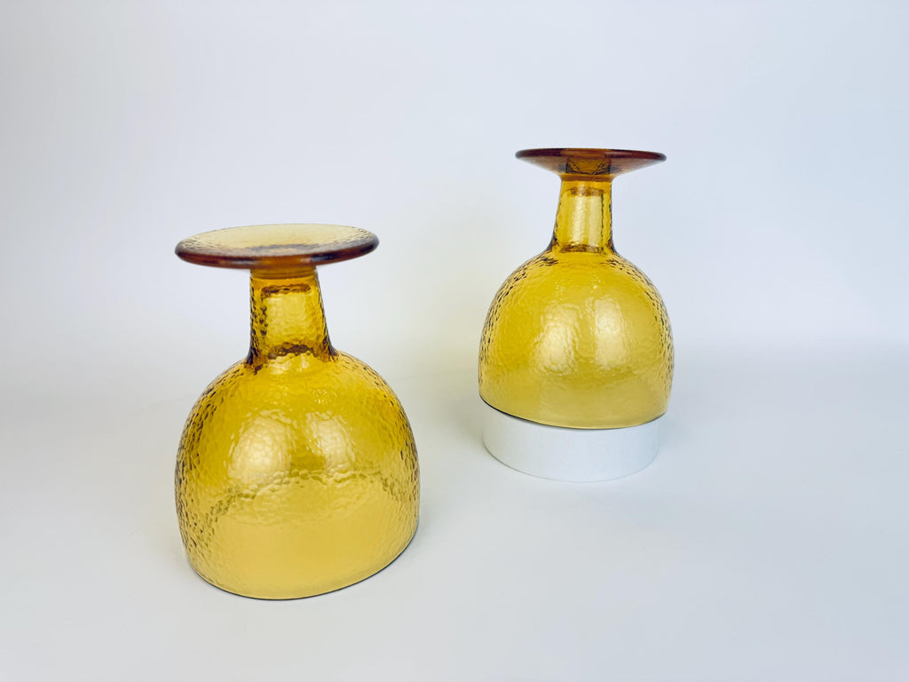 Pair of amber goblets displayed upside down to show base and stem detail