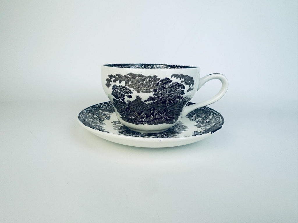 Ceramic cup and saucer with blue floral pattern on a white background