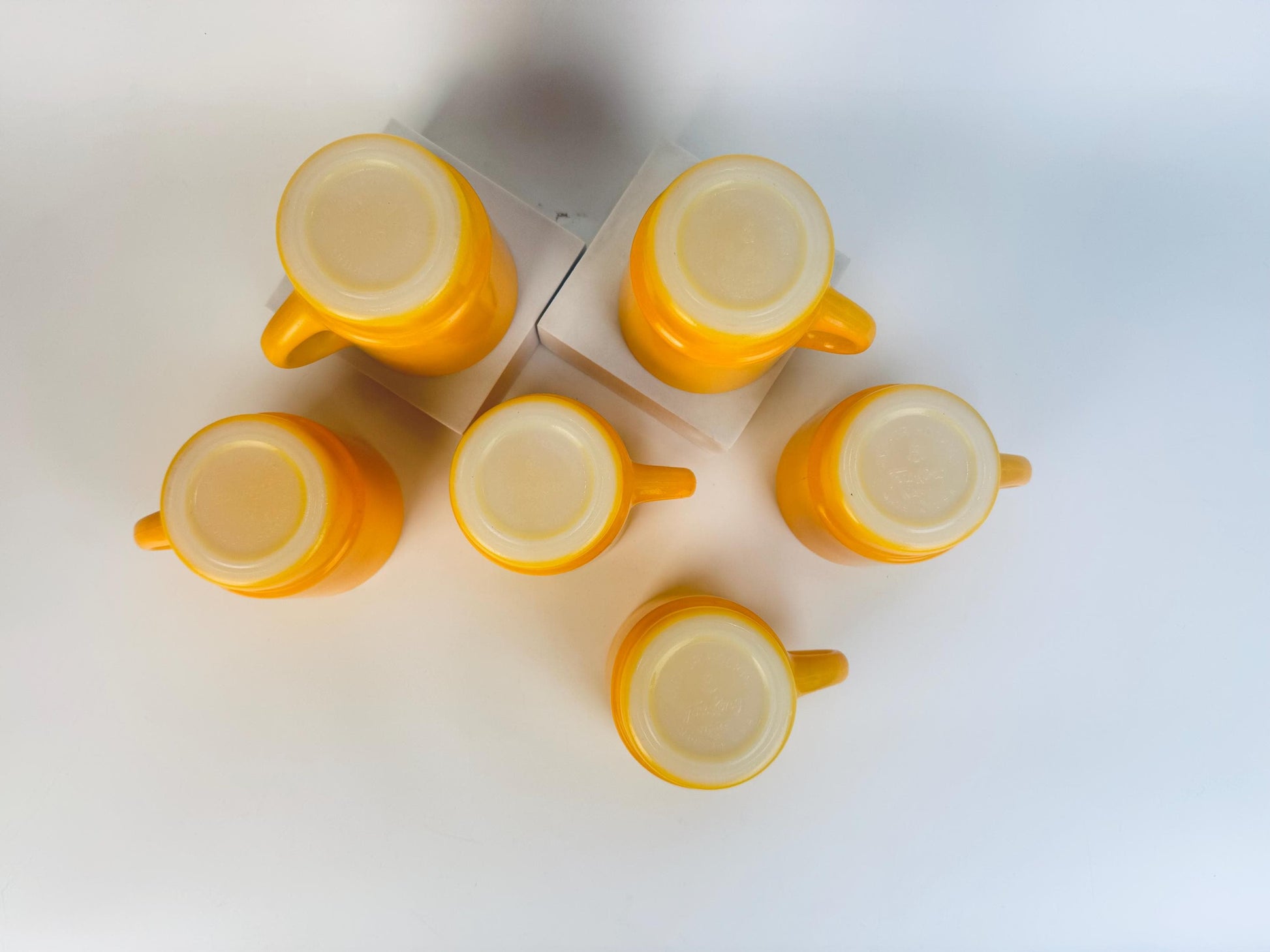 Yellow ceramic mugs on a white background