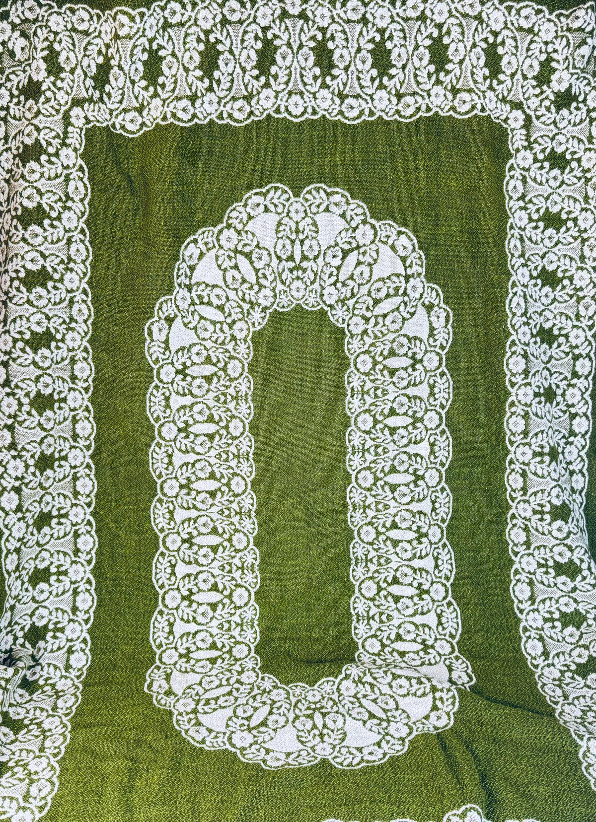 Reversible tablecloth corner flipped to reveal reverse side of woven pattern