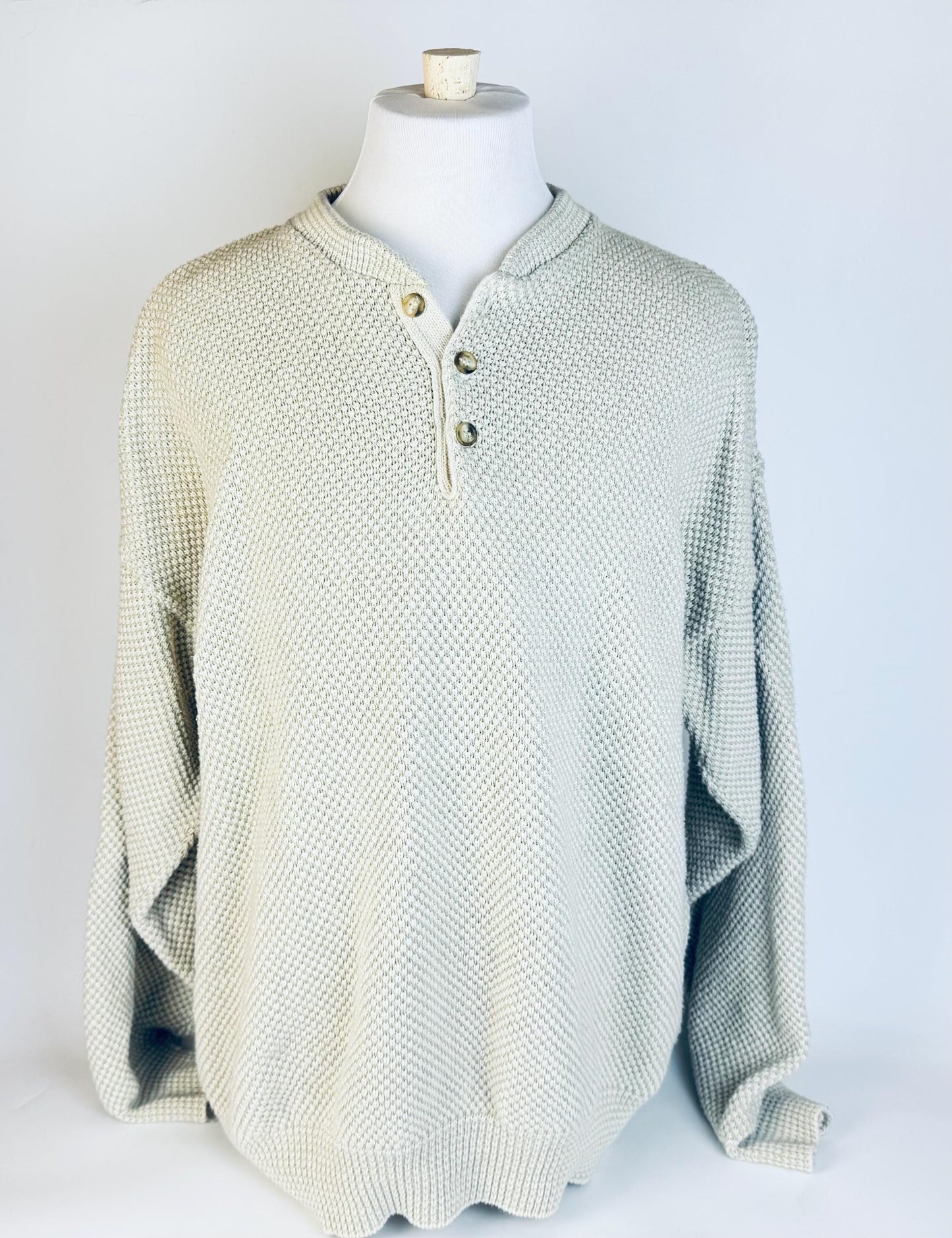 Mannequin wearing a lightly textured sweater on a white background