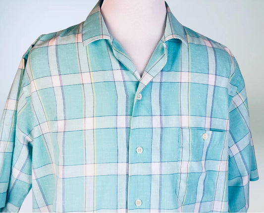 Plaid shirt with light blue, green, and white pattern on a mannequin against a plain background