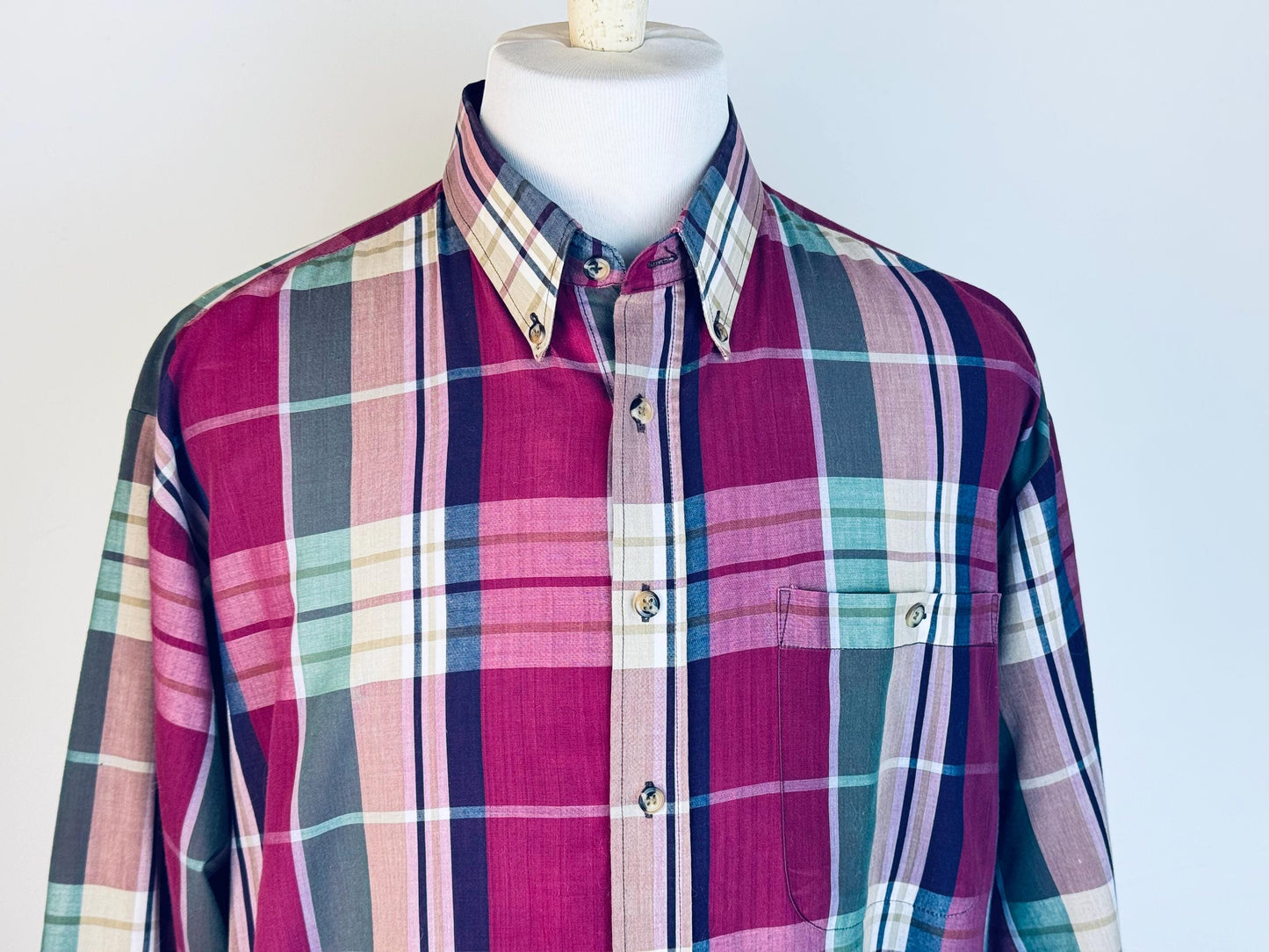 Plaid shirt on a mannequin against a plain background