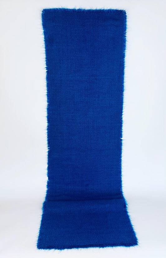 Electric blue table runner with fringe edges on a white background