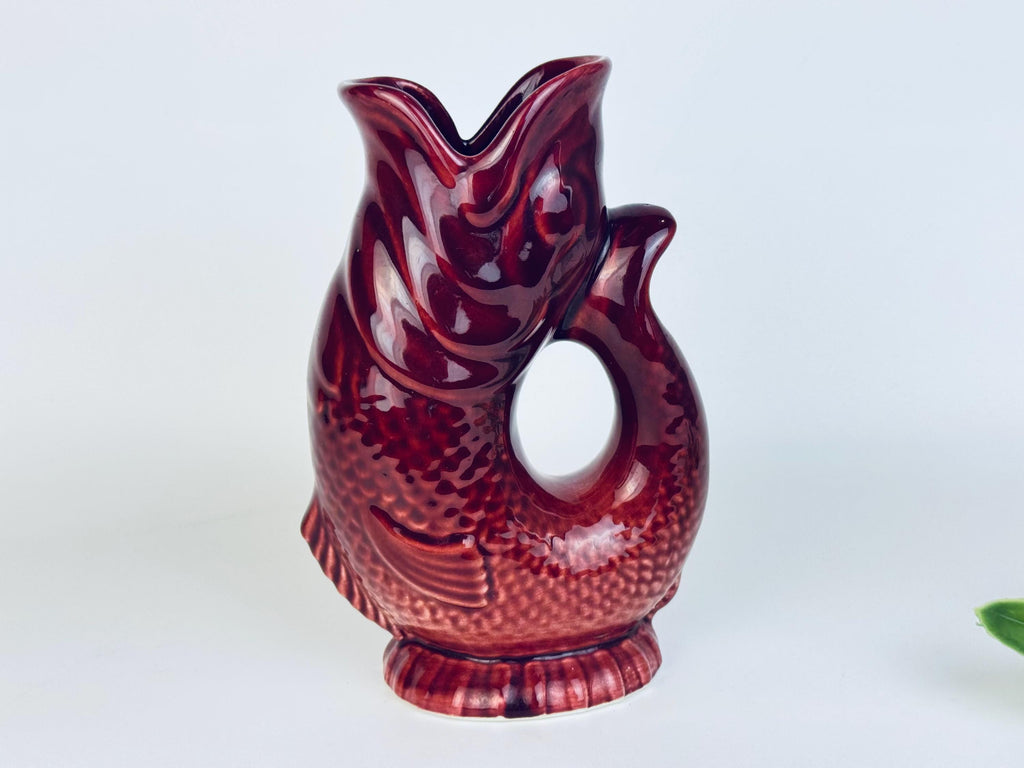 Front view of red ceramic fish jug highlighting detailed scales and textured surface