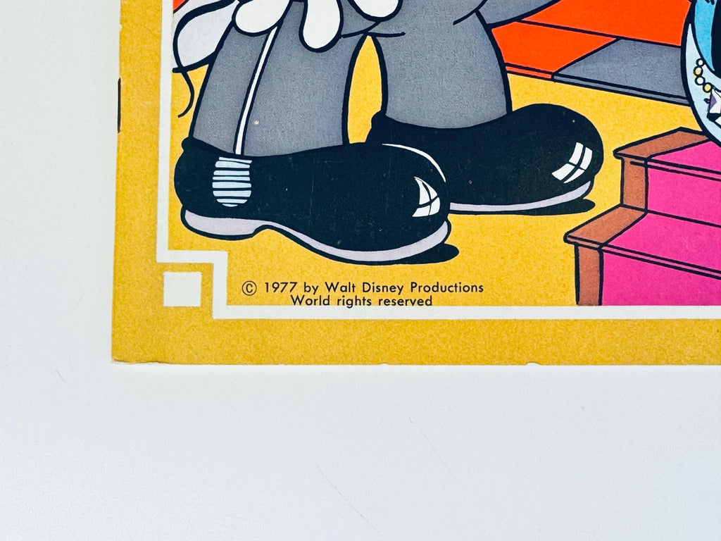 Close-up of lower corner of cover showing illustration details and edges of paper