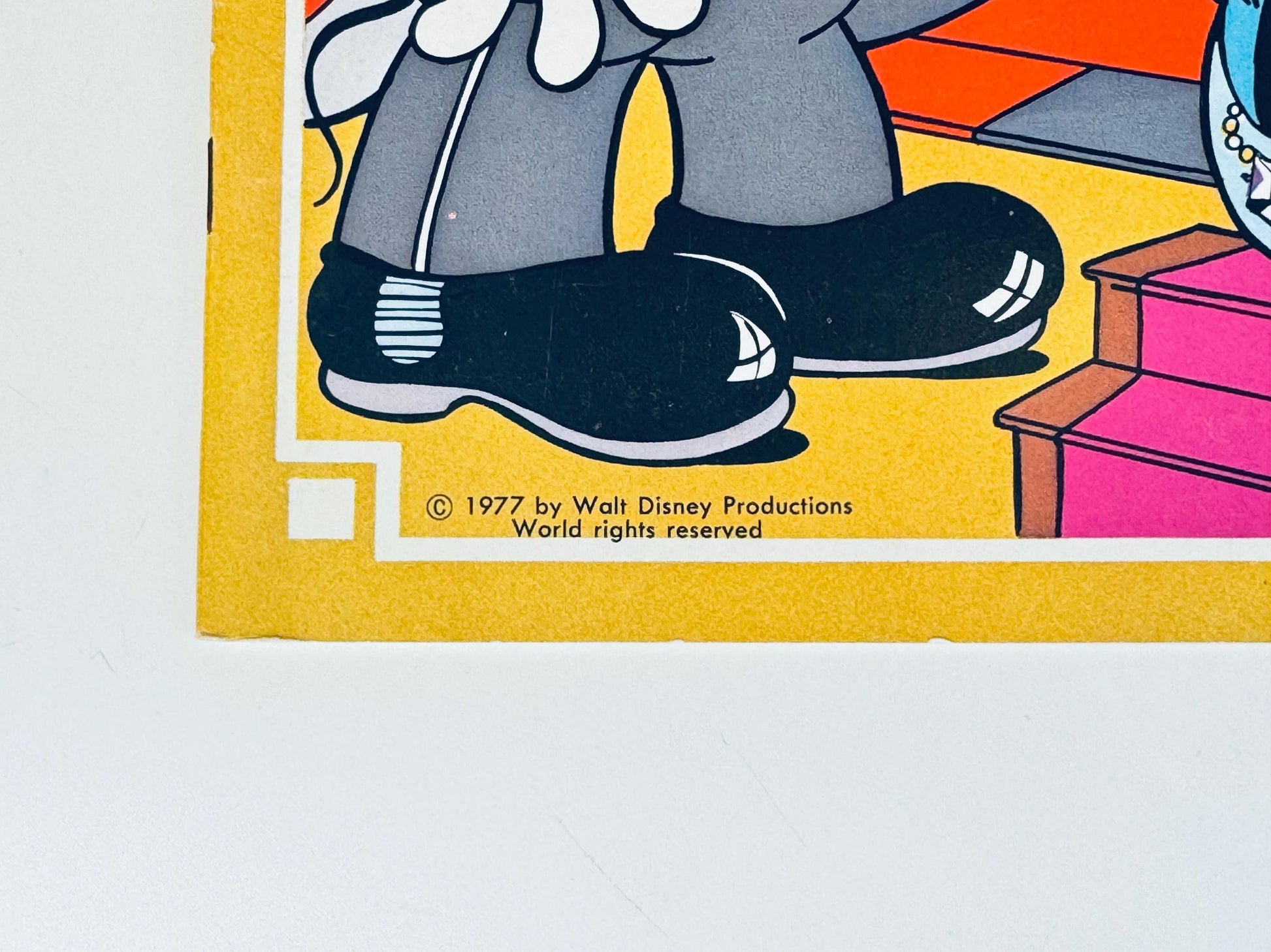 Close-up of lower corner of cover showing illustration details and edges of paper