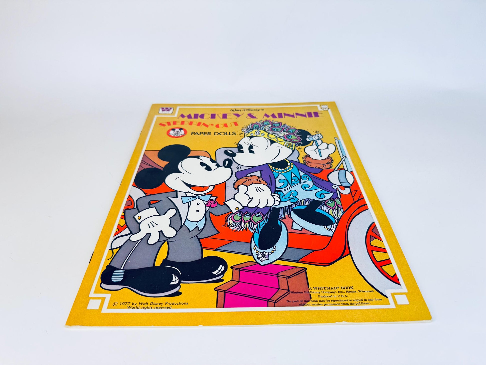 Angled view of full book cover highlighting bright colours and retro Disney artwork