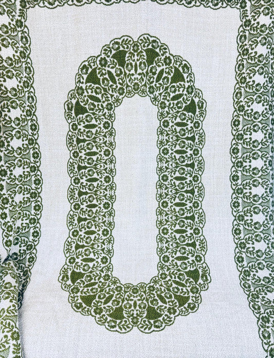 Full view of green and cream jacquard tablecloth with oval floral medallion center