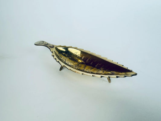 Vintage 1970s brass leaf dish with tripod legs and hand-engraved floral detailing.