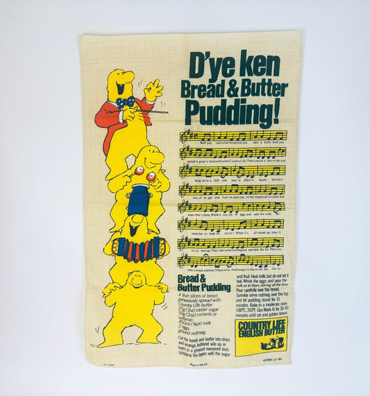 Vintage advertisement for Dye Ken Bread & Butter Pudding with cartoon characters and musical notes.