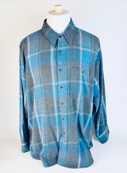 Blue plaid shirt on a mannequin against a white background