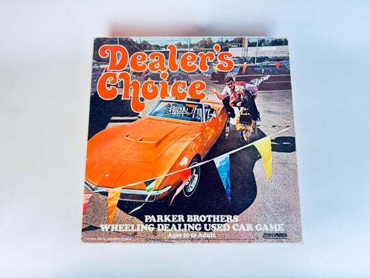 Game box for 'Dealer's Choice' by Parker Brothers featuring an orange car and people around it.