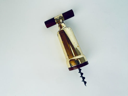 Gold corkscrew on a white background