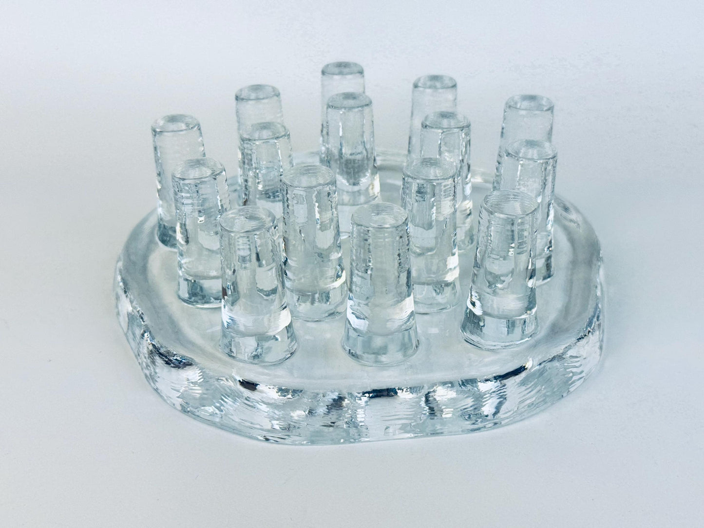 Vintage Georgshütte clear pressed glass tea warmer with raised peg design, 1970s German art glass candle holder photographed on white background.
