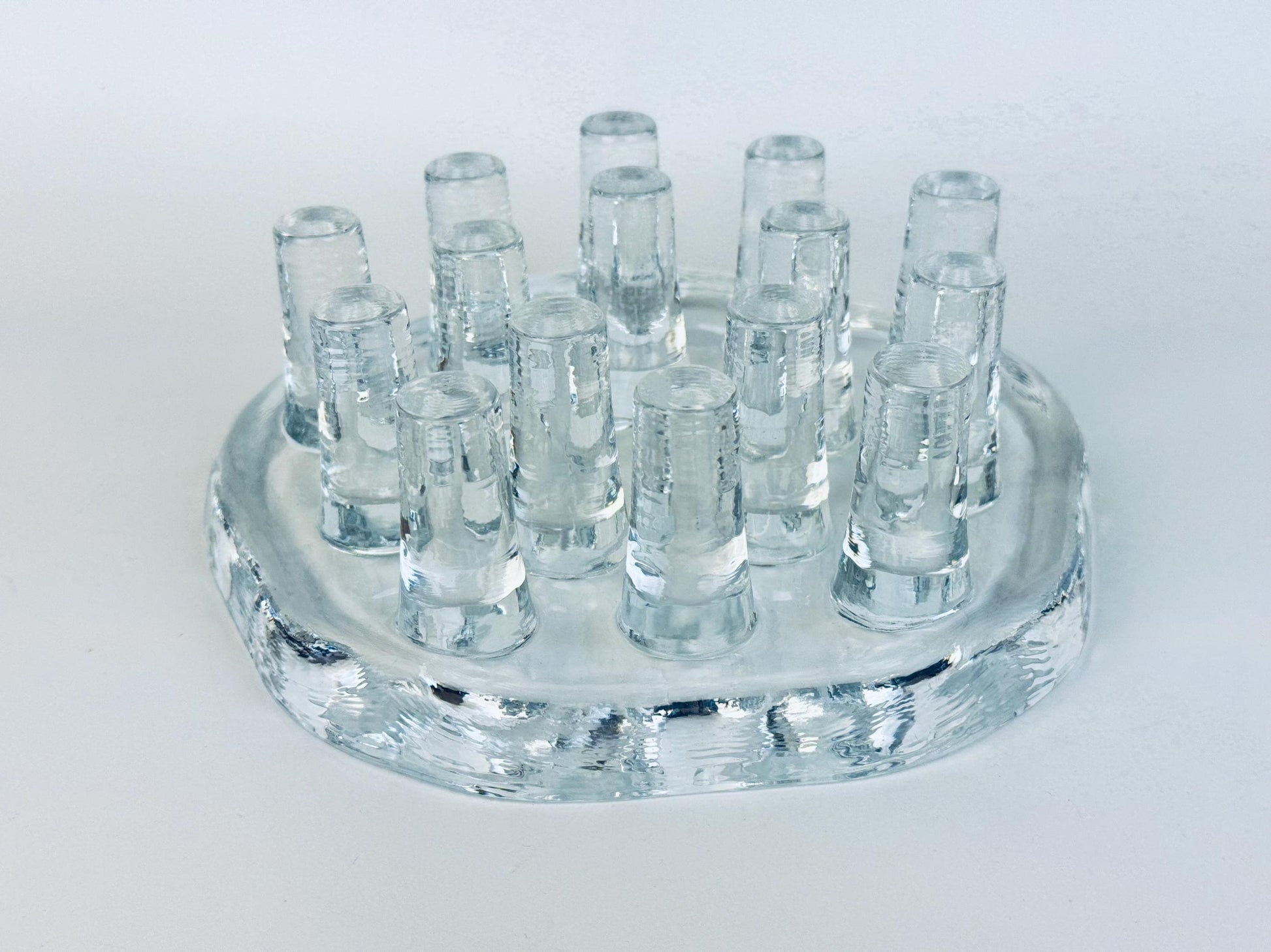 Vintage Georgshütte clear pressed glass tea warmer with raised peg design, 1970s German art glass candle holder photographed on white background.