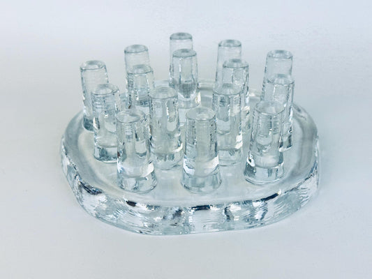 Vintage Georgshütte clear pressed glass tea warmer with raised peg design, 1970s German art glass candle holder photographed on white background.