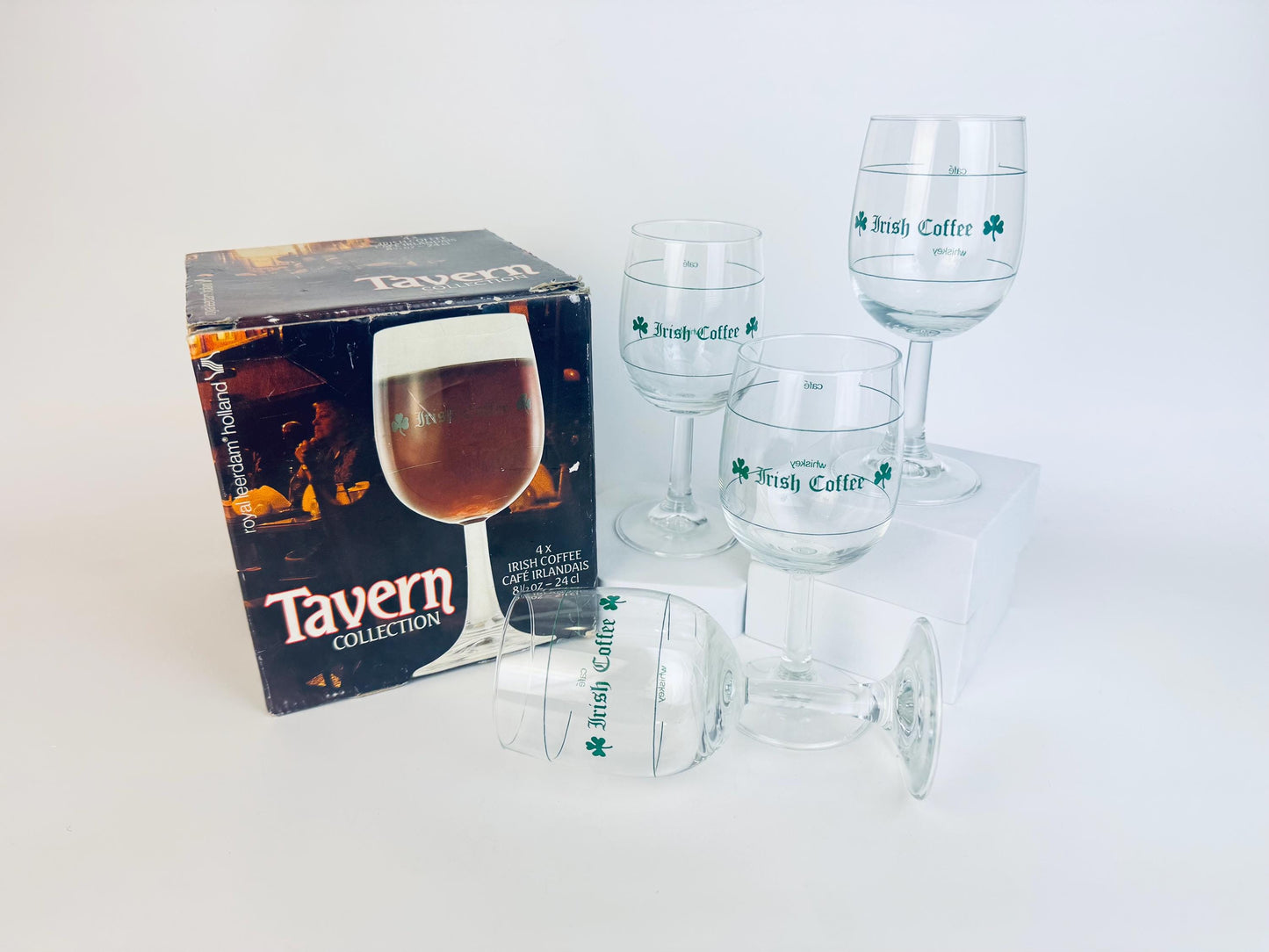 Set of four vintage Tavern Collection Irish Coffee glasses with original box, clear stemware with green shamrock and Irish Coffee print, 1970s–1980s barware.