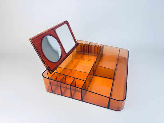 Vintage 1970s dark amber marbled lucite vanity organizer with compartments and flip-up mirror, British Design Reg. No. 1008846.