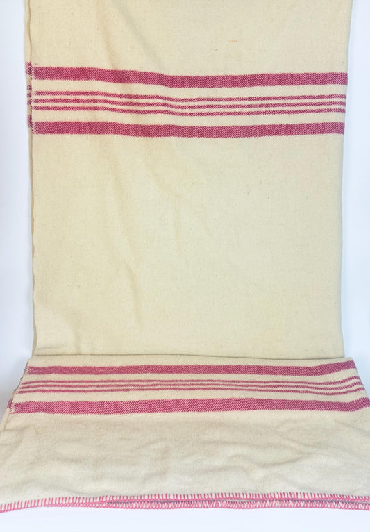 Vintage Brandon Woollen Mills beige wool blanket with bold pink stripes, laid flat to show full pattern and stitched edging detail.