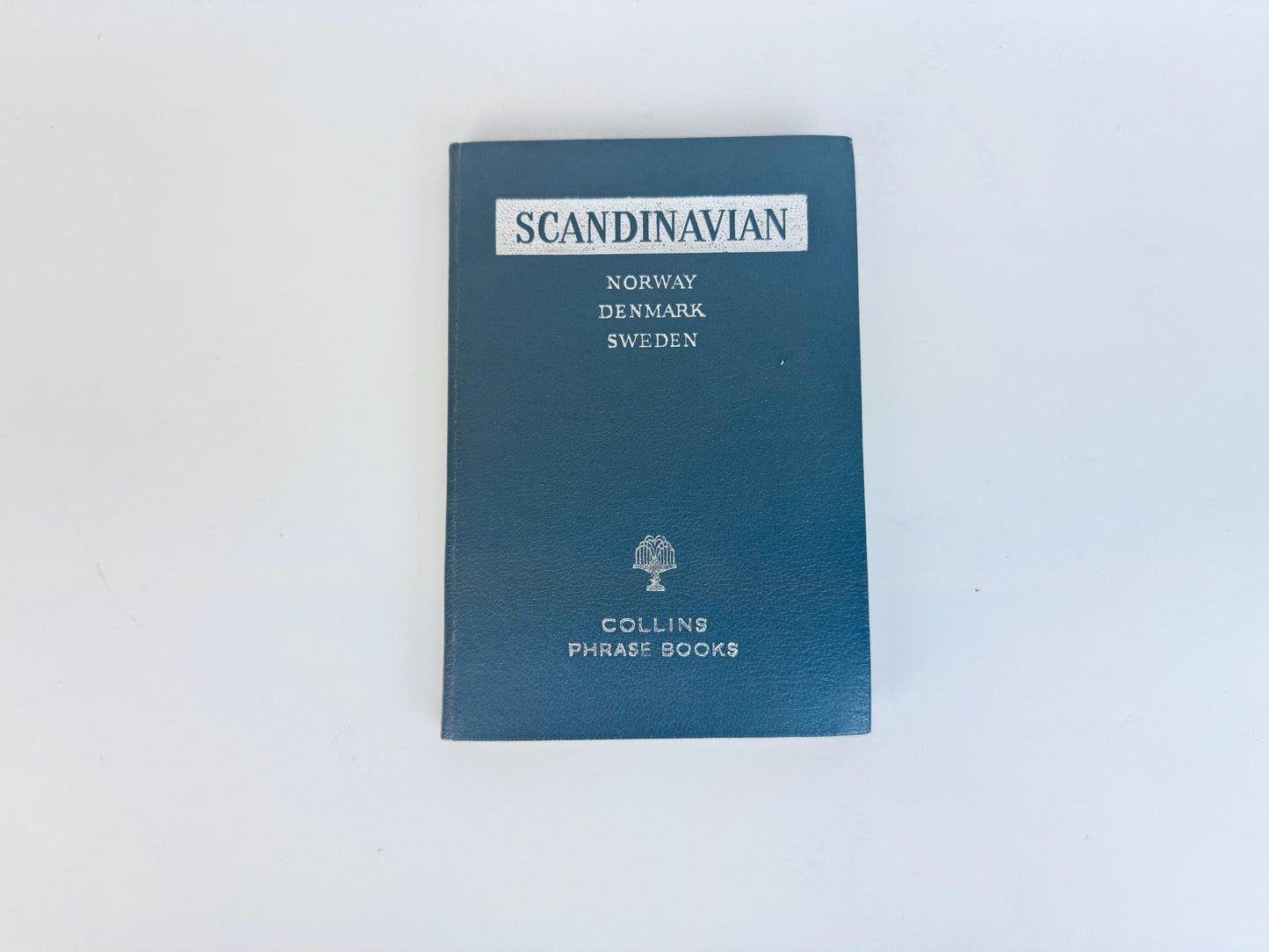 Grey book titled 'Scandinavian' by Collins on a white background
