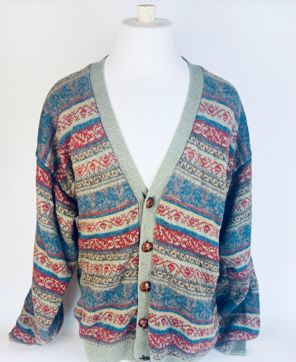 Patterned cardigan on a mannequin against a white background