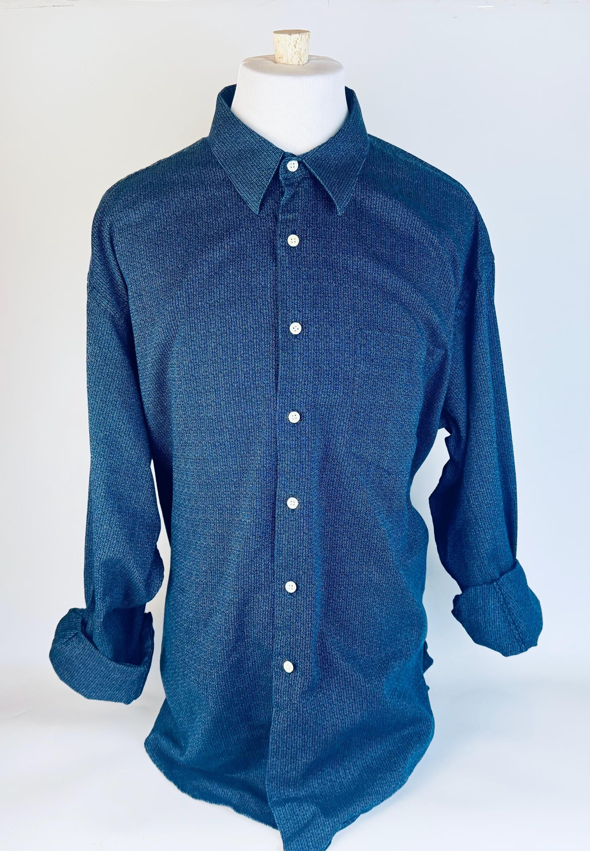 Blue button-up shirt on a mannequin against a white background