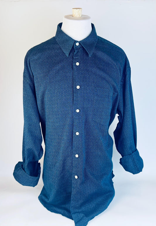 Blue button-up shirt on a mannequin against a white background