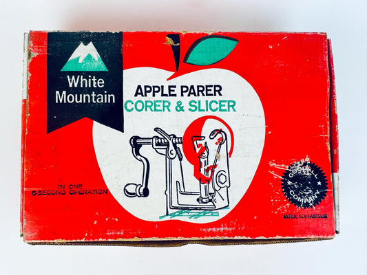 Vintage White Mountain apple parer, corer, and slicer box on a white background
