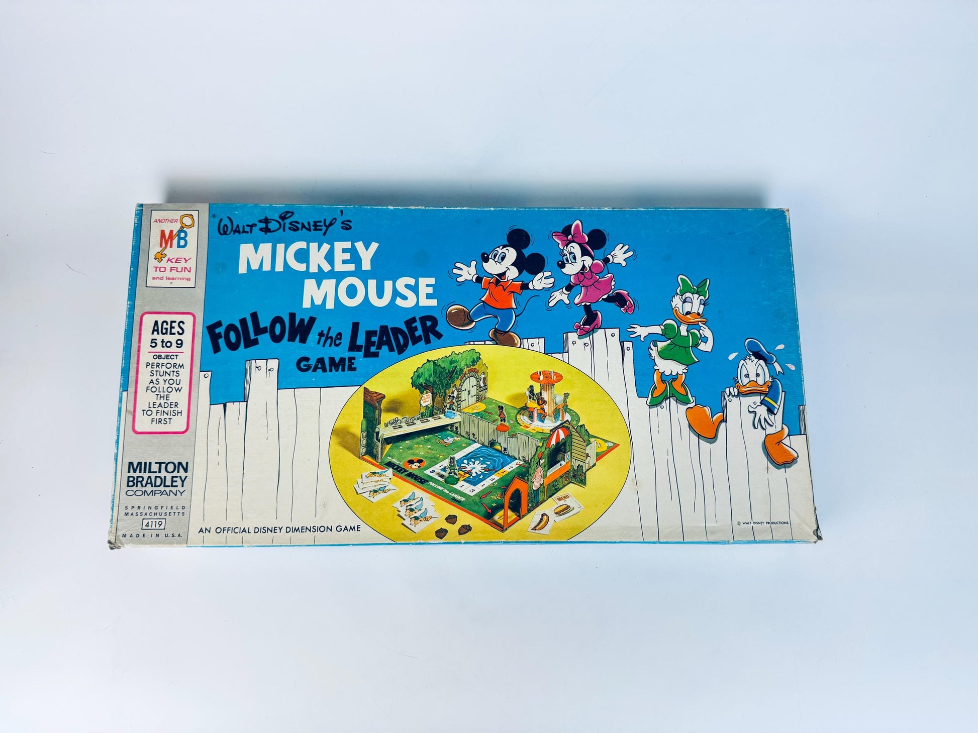 Vintage Mickey Mouse board game box by Milton Bradley on a light blue background