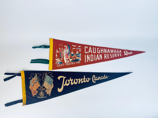 Two vintage-style pennants with 'Caughnawaga Indian Reserve, Que.' and 'Toronto Canada' text on a white background.