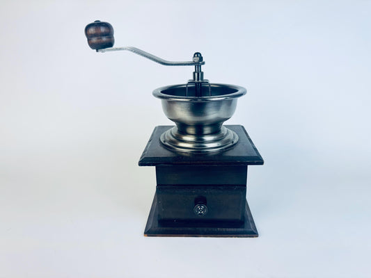 Vintage manual coffee grinder on a white background
