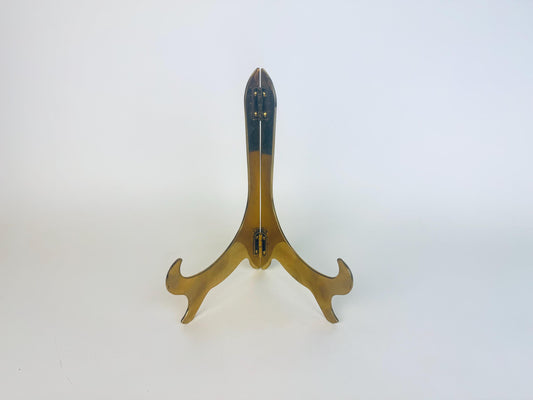 Brass stand with a blue object on a white background