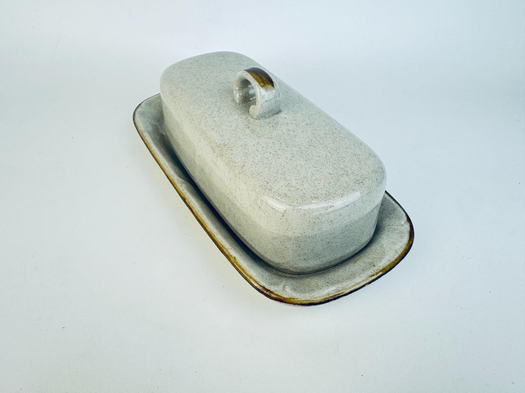 Ceramic butter dish with a lid on a white background