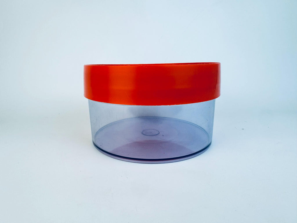 Clear container with a red lid on a white background