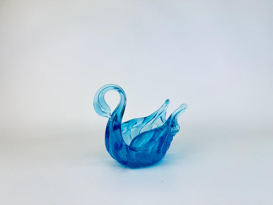Blue glass swan on a white background