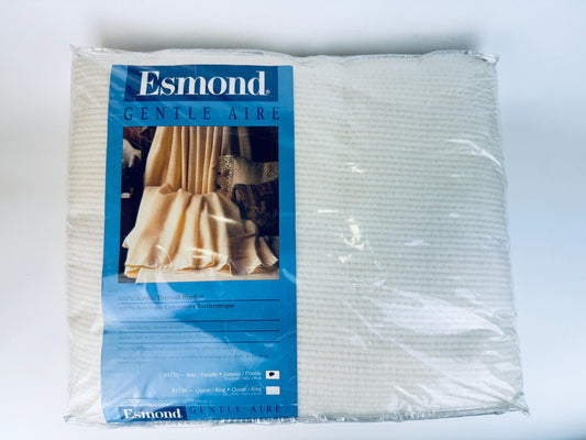 Packaged Esmond 'Gentle Aire' air waffle knit blanket on a white background