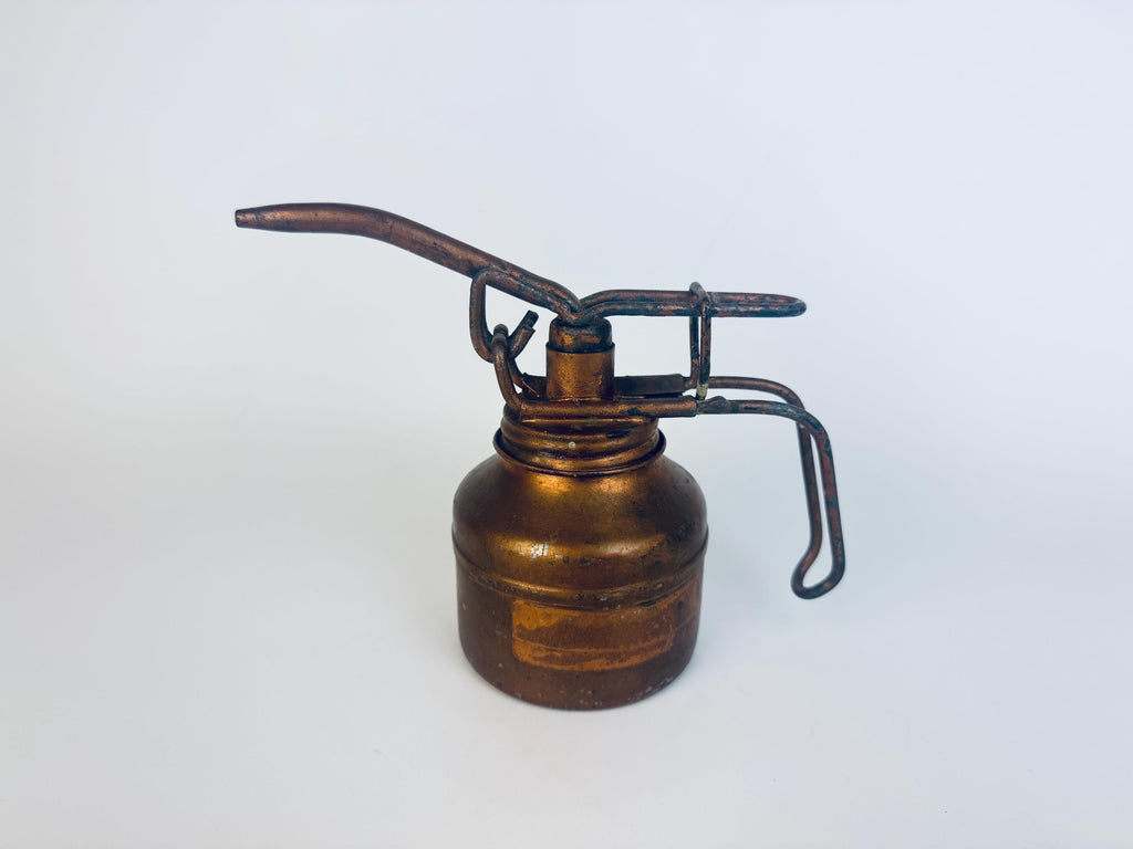 Bronze oil can with pump on a white background