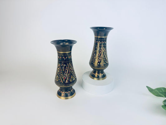 Two decorative vases with black and gold patterns on a white background