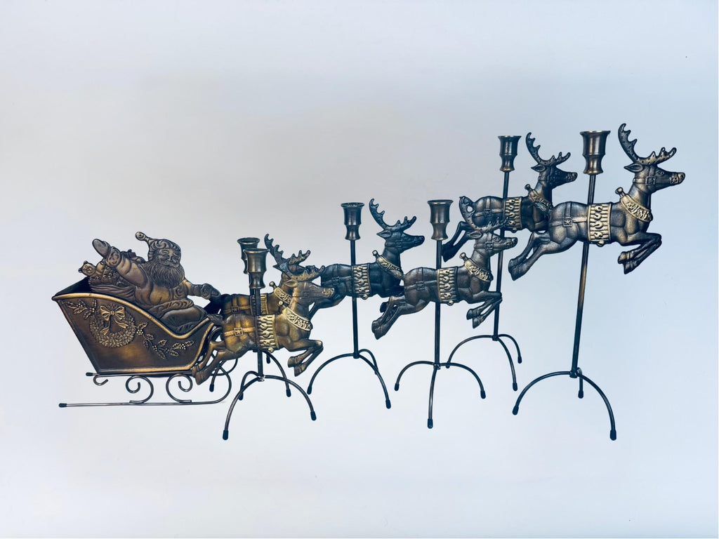Decorative metal candleholder centrepiece sculpture with a sleigh and reindeer.
