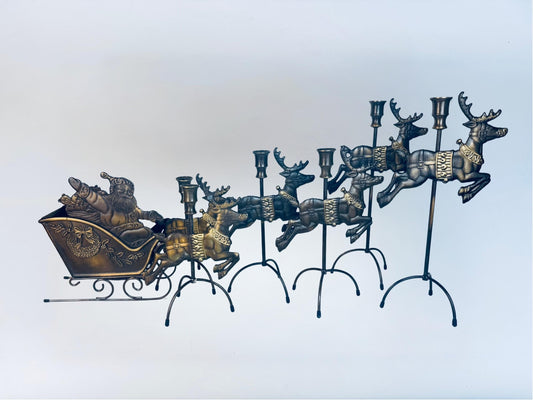 Decorative metal candleholder centrepiece sculpture with a sleigh and reindeer.